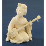 Small Japanese ivory okimono of a kneeling geisha playing a shamisen, approximately 5cm in height