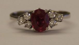 Tested as white gold ring with central ruby (1.0ct) flanked by 6 small diamonds (0.36ct in total),