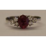 Tested as white gold ring with central ruby (1.0ct) flanked by 6 small diamonds (0.36ct in total),