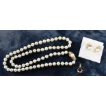 Cultured pearl necklace comprising 73 evenly matched pearls with an 18ct gold diamond, ruby and