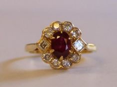 18ct gold ruby and diamond cluster ring with central ruby 0.60ct surrounded by 8 round and 2