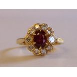 18ct gold ruby and diamond cluster ring with central ruby 0.60ct surrounded by 8 round and 2