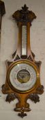 Ornately carved late 19th century oak aneroid barometer Ht 90cm
