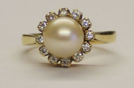 18ct gold diamond cluster ring with central pearl, weight 6.1g size M