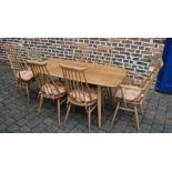 Ercol dining table 150cm by 76cm with 6 dining chairs including 2 carvers