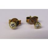 Pair of 18ct gold diamond solitaire earrings, total 0.20 ct (0.10 ct each) with 18ct gold