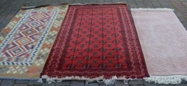 Iranian red ground Balochi rug 195cm by 121cm with 2 others