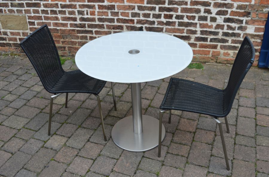 Circular glass top steel table with 2 chairs