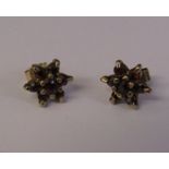 Pair of 9ct gold garnet set star earrings weight 1.1 g