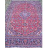 Traditional red ground Persian Kashan carpet 290cm by 192cm