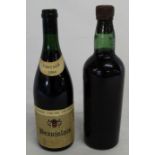 Vintage bottle with no label or stamp containing possibly red wine or port & bottle of Andre