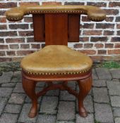 Antique leather upholstered cock fighting chair with folding reading rest