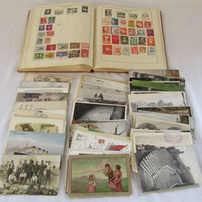 Vintage stamp album of World and UK stamps together with assorted postcards inc Titanic and WWI