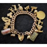 9ct gold bracelet with padlock clasp with 1915 full sovereign, 14 charms stamped 9ct & 3 charms
