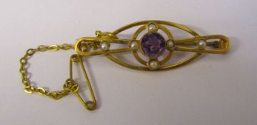 Tested as 9ct gold amethyst and seed pearl brooch with safety chain, amethyst 6.5 mm, L 4 cm, weight