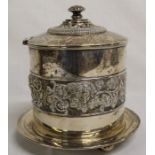 Edwardian silver biscuit barrel on bun feet with fruiting vine and classical head frieze decoration,