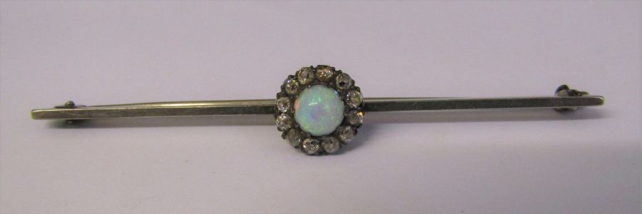 Tested as platinum bar brooch with opal and diamonds L 6.5 cm total weight 4.7 g