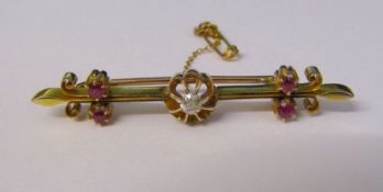 Tested as 15ct gold diamond and ruby bar brooch with safety chain, diamond 0.08 ct,  L 5 cm weight