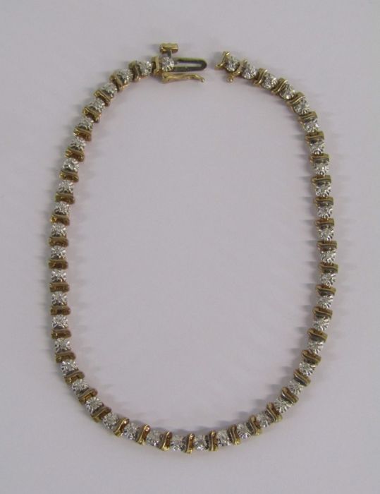 9ct gold diamond tennis bracelet with illusion set stones - length 19.4cm - weight 6.6g