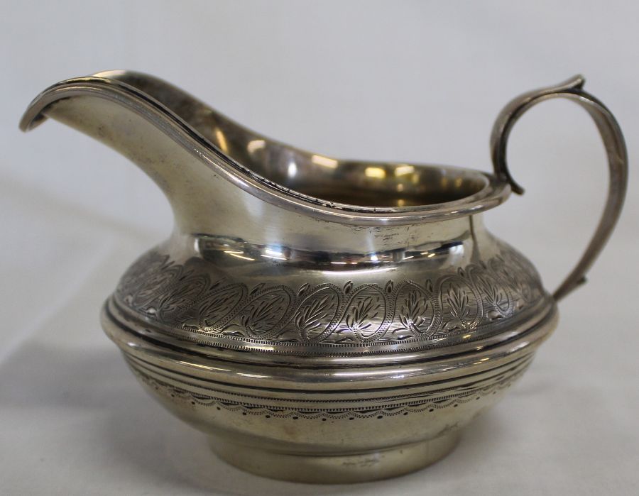 Victorian silver jug with engraved decoration and inscription "Presented by the Earl of