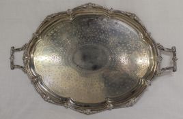 Large late Victorian silver oval two handled tray with classical border and central engraved detail,