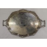 Large late Victorian silver oval two handled tray with classical border and central engraved detail,