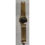 Gents 9ct gold Omega wristwatch with black dial and gold baton markers, manual wind movement, on