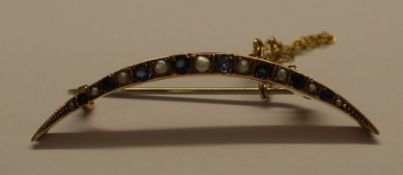 Tested as 9ct gold crescent brooch set with sapphires and seed pearls 2.7g