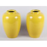 A pair of yellow enamel oviform vases, 8" high (chips to necks), and two 19th century copper