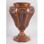 A walnut and cane sided stick stand, on octagonal base, 17 3/4" high