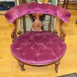 A walnut splat back tub chair, upholstered in a purple velour, on turned and fluted supports