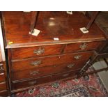 A Georgian mahogany chest of two short and three long graduated drawers with pierced brass