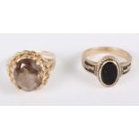 A yellow metal and onyx ring, stamped 10k, size K, and a yellow metal and smokey quartz ring,