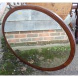 An early 20th century walnut and line inlaid oval bevel-edged framed wall mirror, plate 34" x 26"