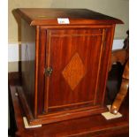 An early 20th century mahogany and inlaid cupboard with adjustable shelves enclosed panel door,