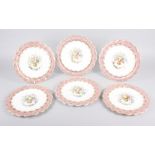 Six 19th century bone china plates, decorated with baskets of flowers and fruit with pink and gilt