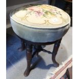 A mahogany piano stool with adjustable seat, upholstered in a sage velour, on splay supports