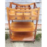 A mahogany three-tier whatnot/bookstand, fitted two drawers, on brass castors, 27" wide x 21" deep x