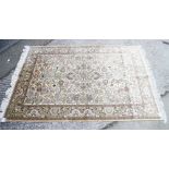A Persian silk rug with all-over scroll and flower design on a light ground and multi-bordered in