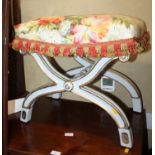 A painted and gilt wood 'X' frame dressing stool, upholstered in a glazed cotton chintz, 22" wide