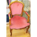 A polished as walnut and carved showframe open armchair, upholstered in a pink velour, on cabriole