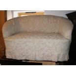 A kidney-shaped two-seat settee with floral loose cover, on square taper supports, 56" wide x 32"