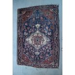 A Herati rug with central medallion on a white floral ground, in deep blue borders, 40" x 55"