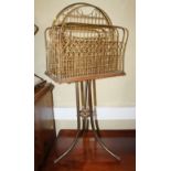 A 19th century brass wire work four-division magazine rack, on tripod splay support, 33" high