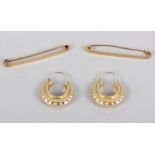 A 9ct gold bar brooch, 1.9g, a bar brooch stamped 15ct, 2.8g, and a pair of 9ct gold hoop