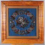 A mid Victorian beadwork panel with floral decoration, 15" x 14 3/4", in maple frame
