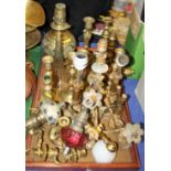 A pair of enamelled brass candlesticks, oil lamps, wall lights and other items