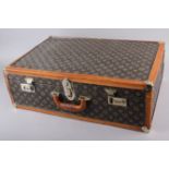 A leather bound travel case and a collection of fur collars, tippets, etc