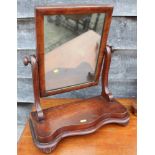A 19th century mahogany swing frame toilet mirror, on serpentine plateau base, 17 1/2" wide x 8"