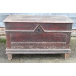 An 18th century Continental cherrywood and oak coffer with wrought iron carry handles and candle